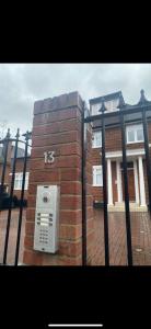 a brick building with a pay phone on a fence at Hendon Escape Luxury Apartment with En-suite Bath in Hendon