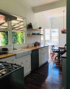 a kitchen with a sink and a stove top oven at Gallery House Dwellingup in Dwellingup