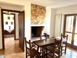 a dining room with a table and chairs and a fireplace at Casa vacanze Borgo Rondini in Rocca di Cambio