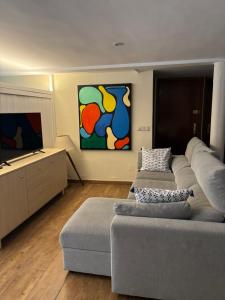 a living room with two couches and a flat screen tv at Good Vives Free SL in Madrid