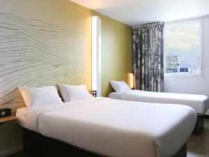 a hotel room with two beds and a window at B&B HOTEL Marseille Prado Vélodrome in Marseille
