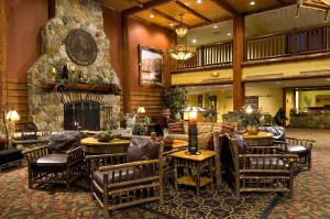 a lobby with chairs and a stone fireplace at Six Flags Great Escape Lodge & Indoor Waterpark in Queensbury