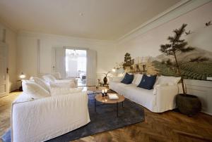 a living room with two white couches and a tree at ApartmentInCopenhagen Apartment 1569 in Copenhagen
