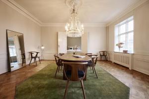 a dining room with a table and a chandelier at ApartmentInCopenhagen Apartment 1569 in Copenhagen