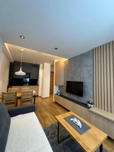 a living room with a couch and a table at Apartman Viktor 302 - Zlatni Javor in Jahorina