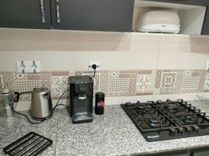 a kitchen counter with a gas stove and a toaster at les temps heureux in Alger