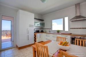 a kitchen with a table with a bowl of fruit on it at Villa Andy Lanzarote in Yaiza