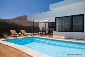 a swimming pool in a villa with a view at Villa Andy Lanzarote in Yaiza