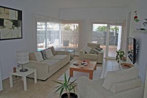 a living room with two couches and a table at Villa Andy Lanzarote in Yaiza