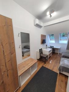a room with a bed and a desk and a mirror at Double room in Pensiunea Nossa Panzió in Corunca
