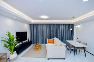 a living room with a couch and a table at Luxury studio apartment near Kigali Convention Center in Kigali
