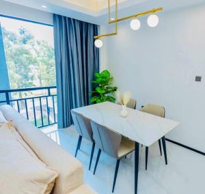 a living room with a white table and a couch at Luxury studio apartment near Kigali Convention Center in Kigali