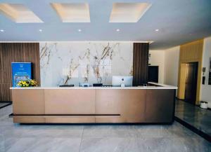 a lobby with a reception desk with a laptop on it at Luxury studio apartment near Kigali Convention Center in Kigali