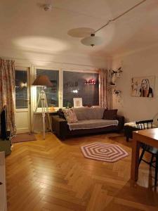 a living room with a couch and a table at Scandinavian design apartment in the center in Rovaniemi