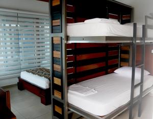 Postel nebo postele na pokoji v ubytování La Bocana de Quiximies Hotel