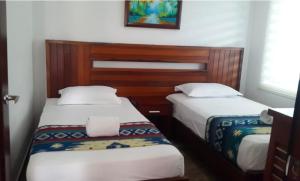 Postel nebo postele na pokoji v ubytování La Bocana de Quiximies Hotel