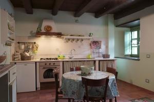 een keuken met een tafel met een tafelkleed erop bij Agriturismo Al Castagno in Abetone
