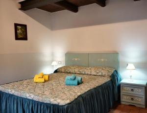 a bedroom with a bed with two pillows on it at Agriturismo Al Castagno in Abetone