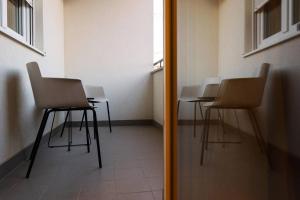 grupa krzeseł w pokoju z lustrem w obiekcie Luxury Infusion by HOME Apartments - Free Parking w Zagrzebiu