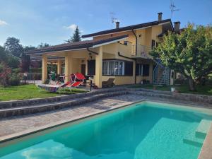 a house with a swimming pool in front of a house at Casa Vacanze Alice e Arianna in Cairo Montenotte