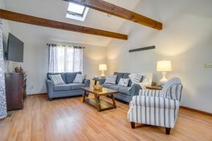 a living room with two couches and a table at 2 Mi to Covells Beach Centerville Home with Deck in Centerville