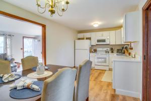 a kitchen and dining room with a table and chairs at 2 Mi to Covells Beach Centerville Home with Deck in Centerville