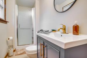 a bathroom with a sink and a toilet and a mirror at 2 Mi to Covells Beach Centerville Home with Deck in Centerville +20 photos
