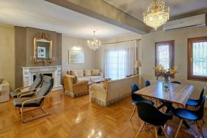 a living room with a table and chairs and a couch at R House Trikala in Tríkala