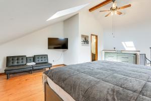 a bedroom with a bed and a couch and a tv at Vernon Township Condo with Balcony Near Ski Lifts! in Vernon Township