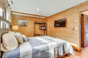 a bedroom with a bed in a wooden wall at Vernon Township Condo with Balcony Near Ski Lifts! in Vernon Township