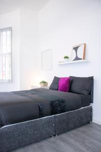 a bedroom with a large black bed in a room at Central Blissful Haven in Liverpool