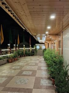 a hallway with potted plants in a building at Hotel Zingkham Residency in Gangtok