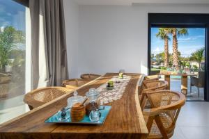 una mesa de madera con un plato de comida. en Penélope Beachfront Villa, en Kremasti