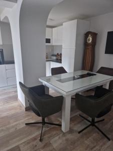 a table and chairs in a room with a kitchen at small apartment for two in Brus