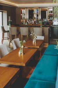 a restaurant with wooden tables and chairs and a bar at Everything Retreat in Mellor