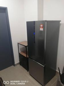 ein großer schwarzer Kühlschrank in einem Zimmer in der Unterkunft Simfoni 2 in Semenyih