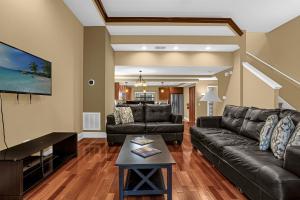 a living room with a couch and a table at 8543 - 4BR Disney World Vacation Townhome in Orlando