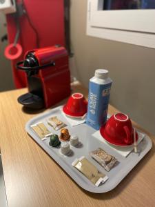 a tray with food on a table next to a coffee maker at ibis Bourg en Bresse in Bourg-en-Bresse