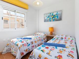 two beds in a room with white walls and a window at Casa del Sol in Salobreña +28 photos