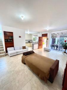 a bedroom with a large bed and a living room at Casa con piscina y salida a la playa in Playas