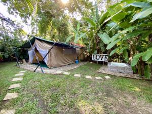 a tent with the word love written on the side of it at Hostel Glamping Mistiko Safari - Carmen de apicala in Carmen de Apicalá