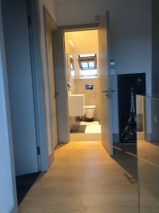 a hallway with a bathroom with a toilet and a sink at Perfect Pad for Solo Travelers in Norwood