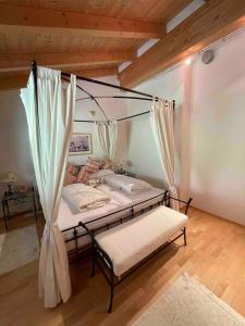 a bedroom with a bed with a canopy at Haus Peppone in Mathon