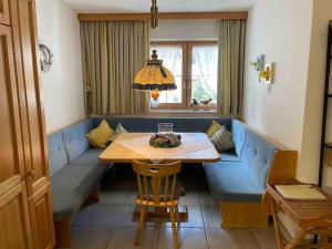 a living room with a blue couch and a table at Haus Peppone in Mathon