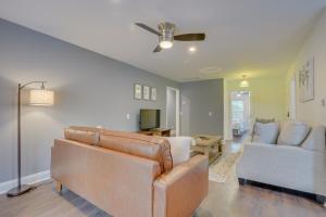 a living room with a couch and a tv at North Charleston Escape about 15 Mi to Dtwn Charleston in Charleston