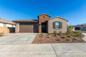a house with a driveway at AT YOUR SERVICE - Modern Amenities, Urban Location, Sophisticated Style in Phoenix