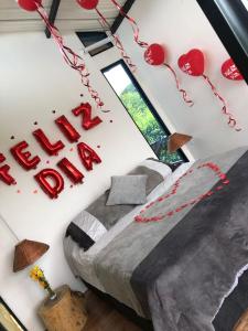 Zimmer mit einem Bett mit roten Herzen an der Wand in der Unterkunft Suite Pacandé , cerca al desierto de la tatacoa in Aipe