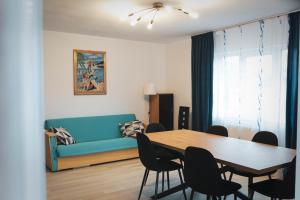 a living room with a table and a couch at TheRefuge in Curtea de Argeş