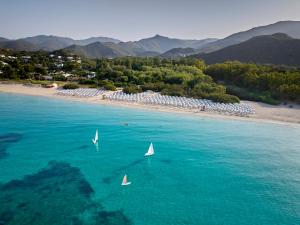 two boats in the water near a beach at Calaserena Resort in Geremèas