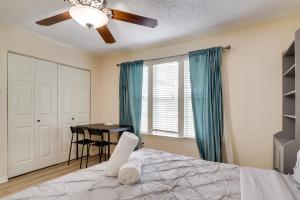 a bedroom with a bed with a ceiling fan and a table at Round Rock Home with Large Yard 20 Mi to Austin! in Round Rock